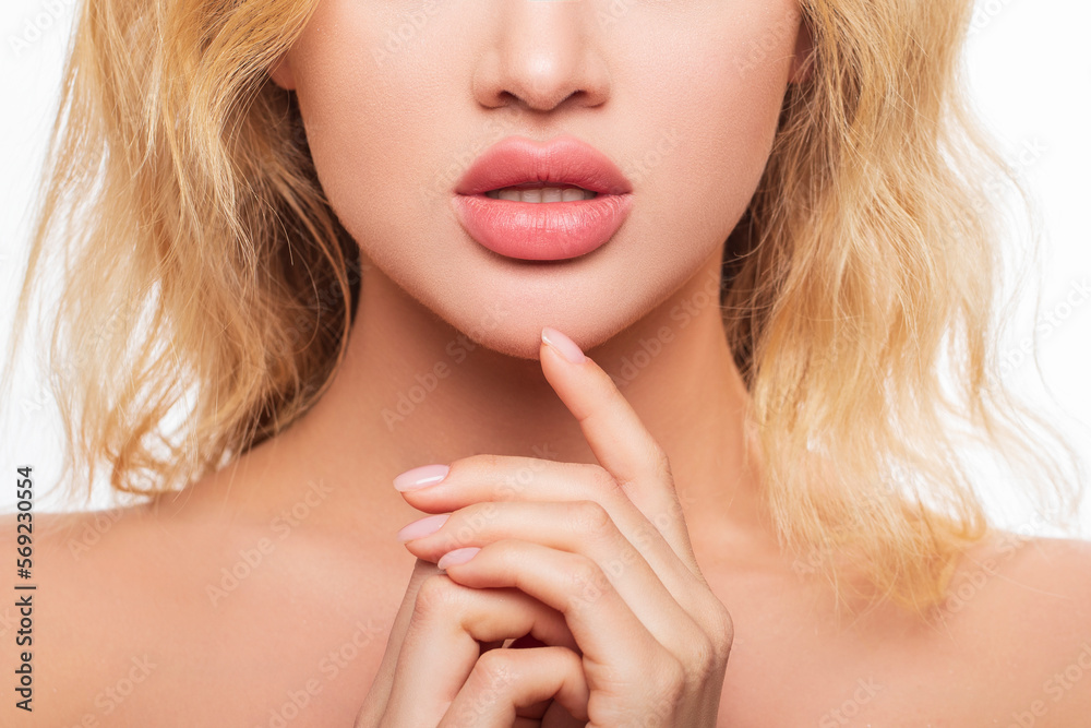 Foto Stock Beautiful lips Close-up. makeup. Lip matte lipstick. Sexy lips.  Part of face, young woman close up. Perfect plump lips bodily lipstick.  peach color lipstick on large lips. Perfect beautiful makeup