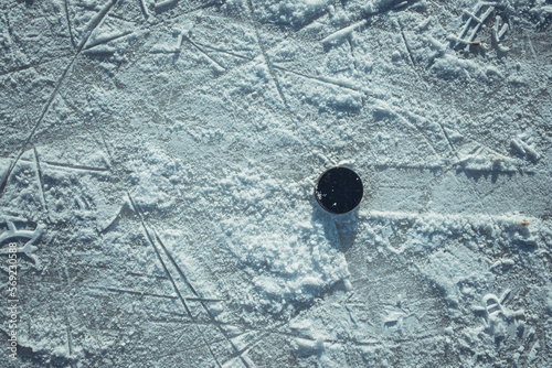 hockey puck lies on the snow macro