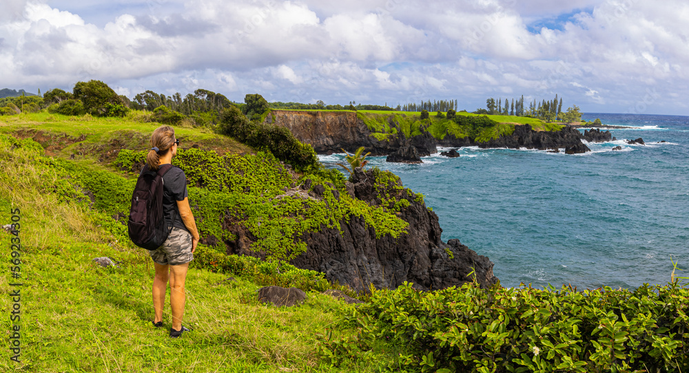 Female Hiker on The Rugged Shoreline Along The Maka Alae Coast, Hana, Maui, Hawaii, USA Female Hiker on The Rugged Shoreline Along The Maka Alae Coast, Hana, Maui, Hawaii, USA