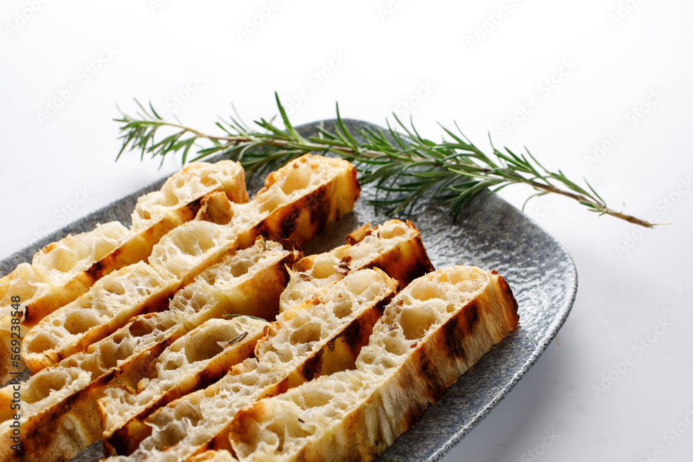 Bread and tomato served on plate Bread and tomato served on plate