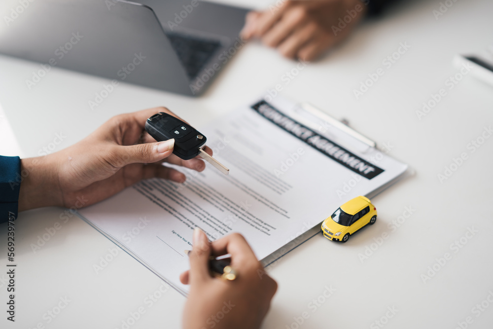 Car agent, sale man explain terms and agreement to customer before giving the car key to customer. Car agent, sale man explain terms and agreement to customer before giving the car key to customer.