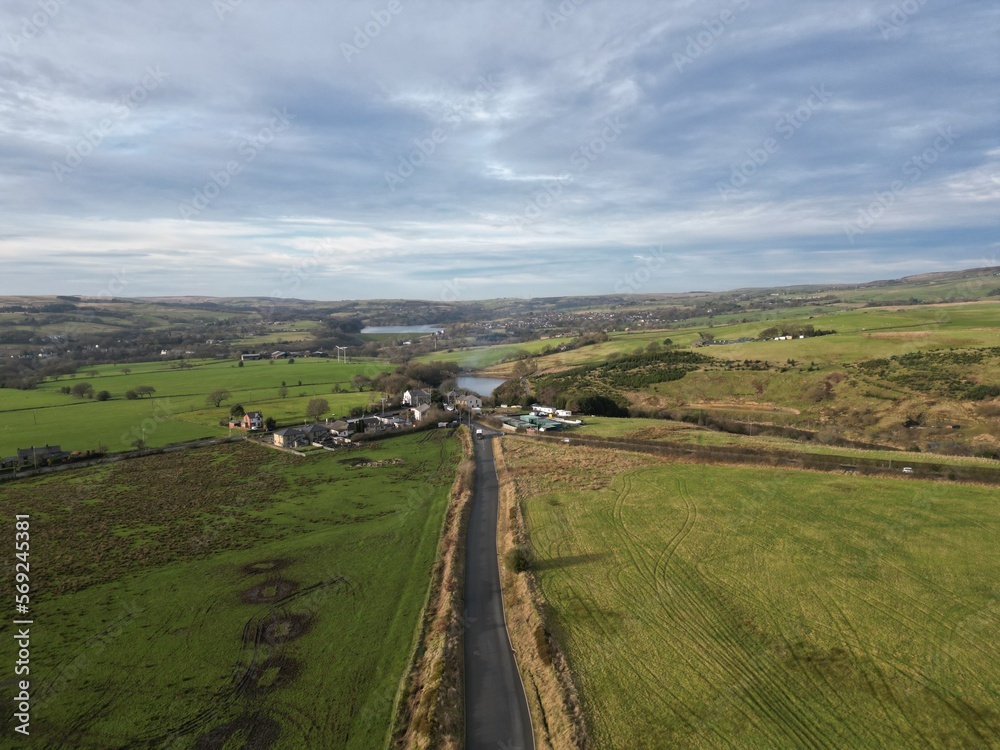 Aerial view of a country road surrounded by farmland and fields. Taken in Bury Lancashire England. 