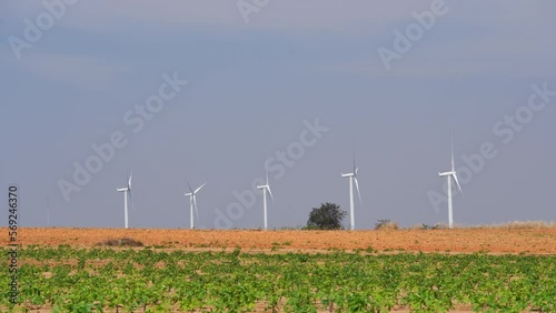 wind turbine in farmland with heat wave distortion. telephoto shot,hand held or holding a camera by hand.