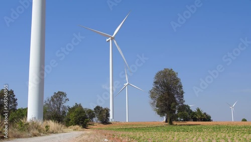 wind turbine in farmland with constant air flow. sustainable energy source for cities and agricultural area. Wide angle shot.