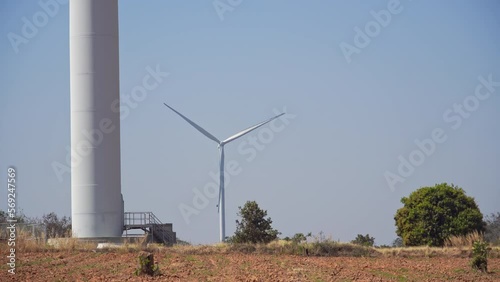 wind turbine in arid landscape with heat wave distortion. telephoto shot,hand held or holding a camera by hand.
