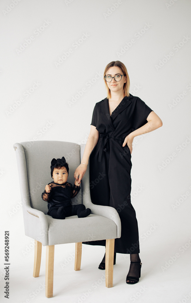 Young caucasian woman stands near her baby daughter from interracial marriage. Young caucasian woman stands near her baby daughter from interracial marriage.