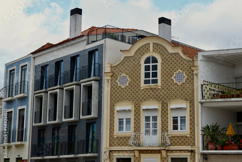 Tiled facades of colourful buildings with windows and balconies outside on the river channel in Aveiro, Portugal. Portuguese architecture