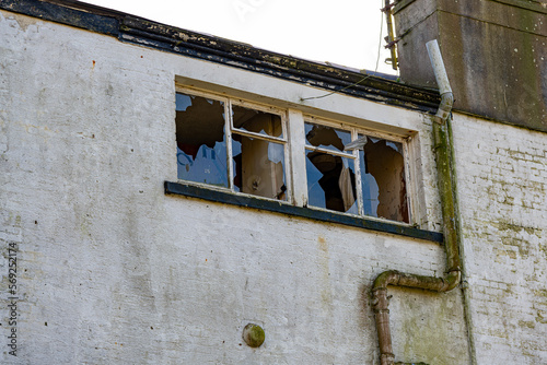 A view of the smashed windows of an abandoned building