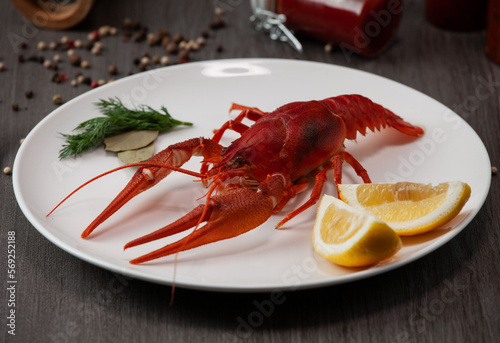 Large boiled crawfish on a plate with lemon and pepper