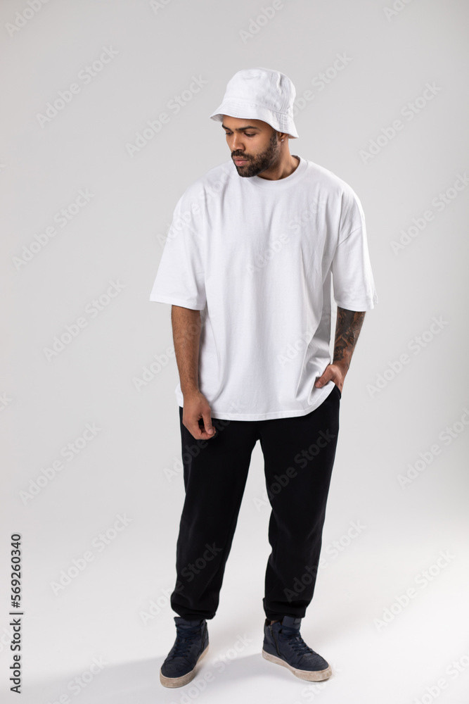 Attractive african american man with a beard dressed in a white t-shirt and panama. Attractive african american man with a beard dressed in a white t-shirt and panama.