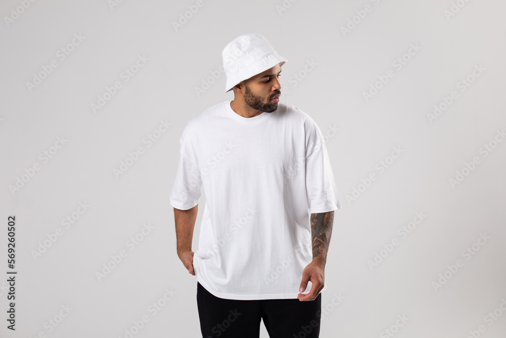 Attractive african american man with a beard dressed in a white t-shirt and panama. Attractive african american man with a beard dressed in a white t-shirt and panama.