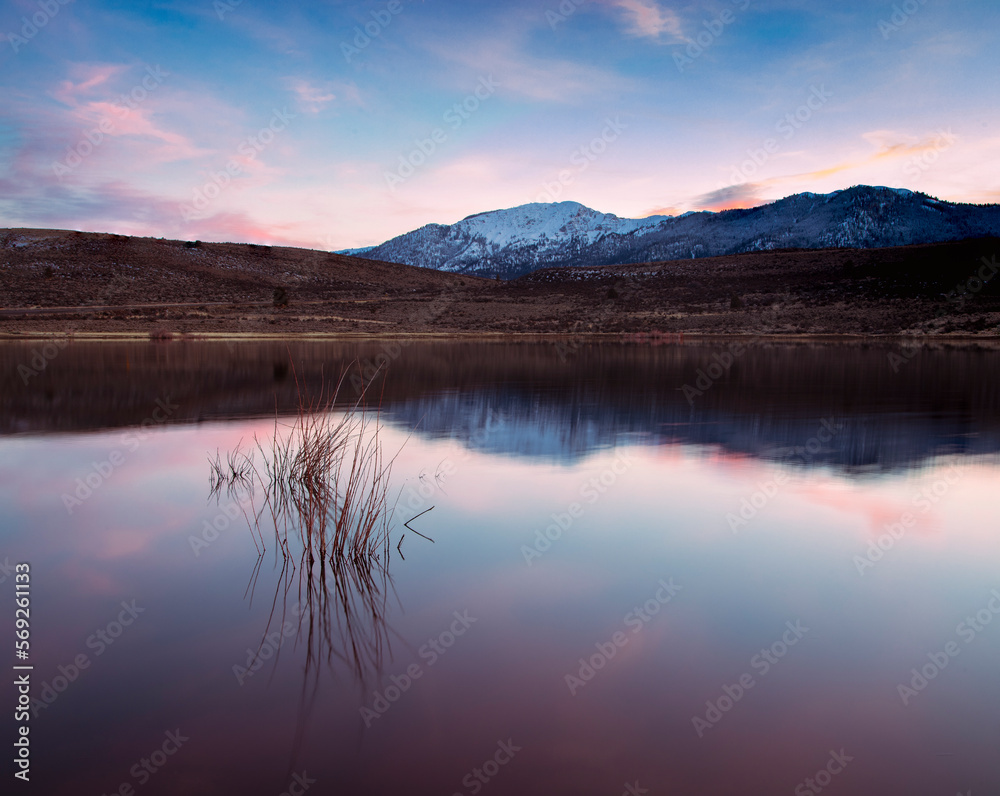 Pastel clouds reflected in Shugru Reservoit with Thompson Peak in the background - Lassen County, California, USA