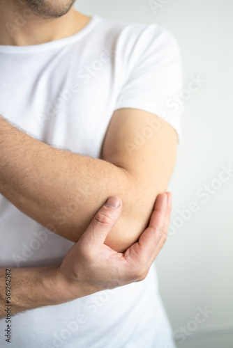 Man holding hands. Elbow pain. focus is highlighted in red. Close. Isolated background.