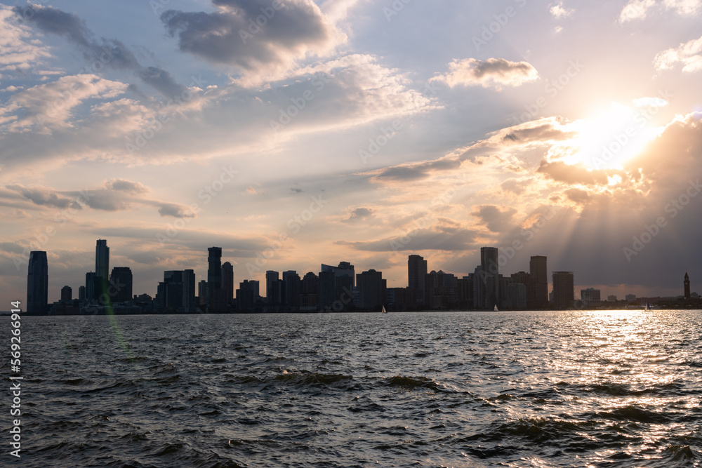 Beautiful Sunset over the Hudson River with the Silhouette of the Jersey City New Jersey Skyline