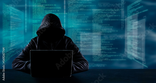 Hacking and technology crime concept. No face hacker with laptop with code background.