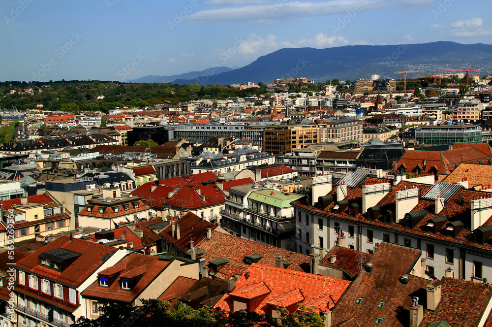 Panoramic view of the city of Geneva and the mountains in the background against a blue sky with clouds in Switzerland