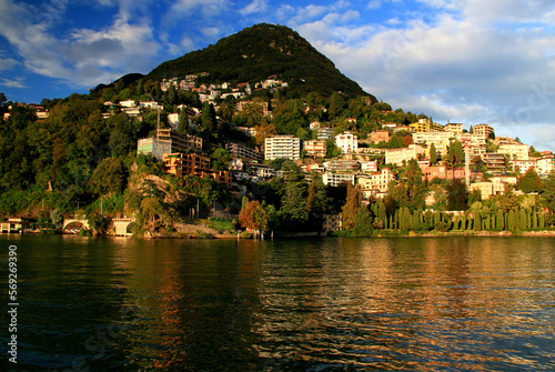Landscape with a view of a hill with houses and Lake Lugano in the city of Lugano, in southern Switzerland 