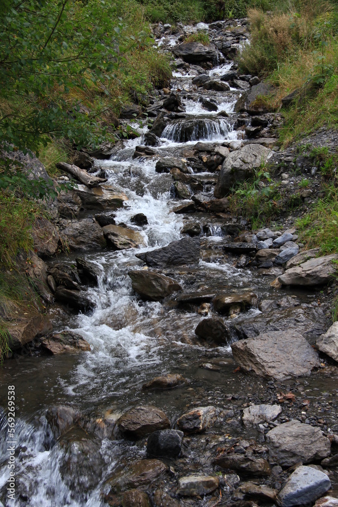A stream that flows between stones and forms a small waterfall in the Lauterbrunnen valley, Switzerland A stream that flows between stones and forms a small waterfall in the Lauterbrunnen valley, Switzerland