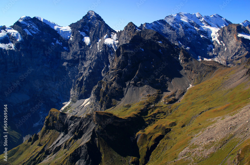 Panoramic view of the landscape with mountains in the foreground against a gradient blue sky on Mount Schilthorn, near Lauterbrunnen and Interlaken in Switzerland