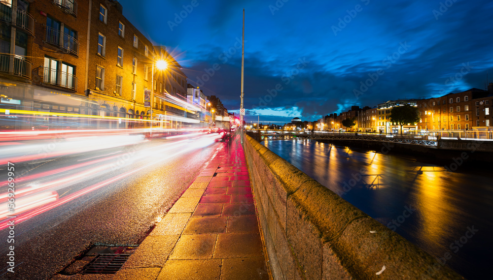 Amazing sunset on the Liffey river with traffic lights - Dublin, Ireland