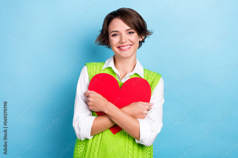 Photo of pretty positive lady wear trendy clothes hold red paper card isolated on cyan color background Photo of pretty positive lady wear trendy clothes hold red paper card isolated on cyan color background