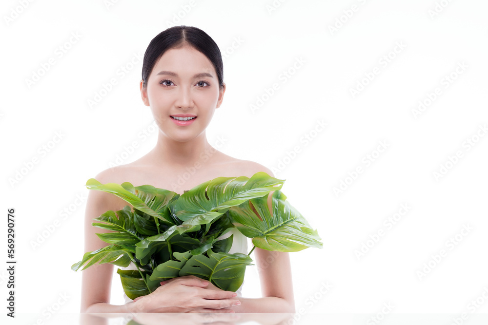 Studio shot. Beautiful asian woman with green plant isolated on white background.Beautiful and healthy skin from natural products. Studio shot. Beautiful asian woman with green plant isolated on white background.Beautiful and healthy skin from natural products.
