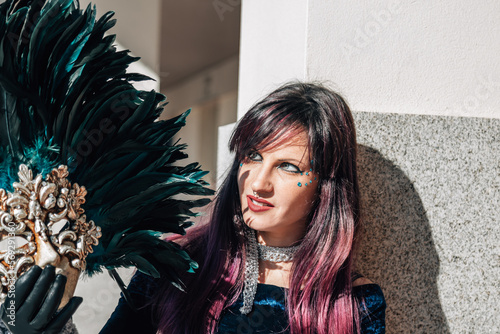 woman holding venetian feather mask photo