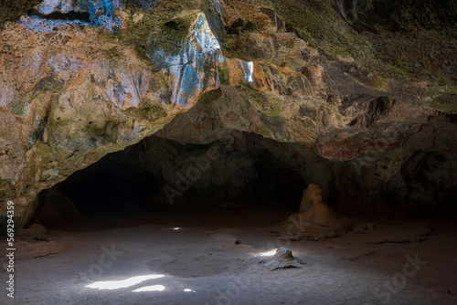 Beautiful view of sunlight through opening in ceiling of Quadirikiri Caves, Arikok National Park, Aruba.  photo