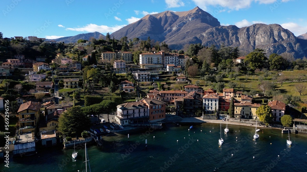 Europe, Lombardy , Drone aerial view of Bellagio, The Pearl of Lake Como,   amazing village in north of Italy - port for boats and beautiful nature with mountain near Milan - Tourist attraction 