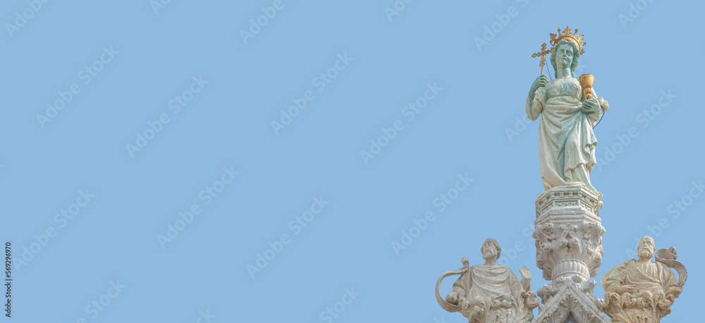 Banner with ancient statue of Maria with cross and holy grail at the roof top decoration of Doge Palace in Venice, Italy, at blue sky background with copy space. Concept of architecture heritage sites