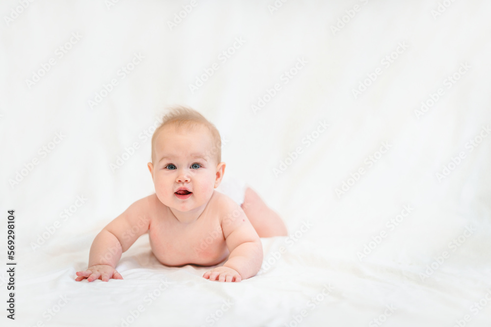 Beautiful Little Caucasian baby in a diaper on a white background Beautiful Little Caucasian baby in a diaper on a white background