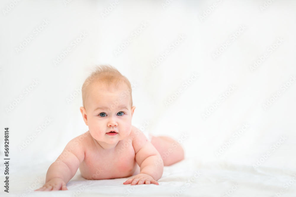 Beautiful Little Caucasian baby in a diaper on a white background Beautiful Little Caucasian baby in a diaper on a white background