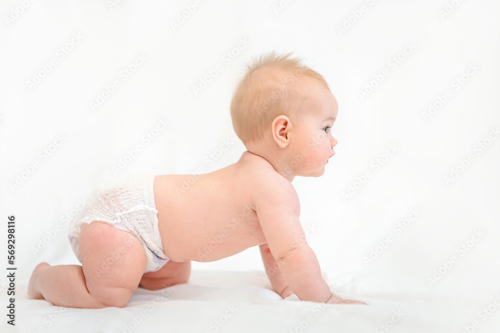 Beautiful Little Caucasian baby in a diaper on a white background Beautiful Little Caucasian baby in a diaper on a white background
