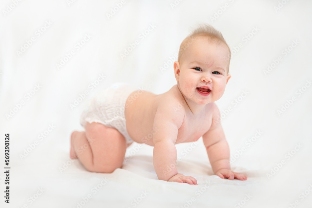 Beautiful Little Caucasian baby in a diaper on a white background Beautiful Little Caucasian baby in a diaper on a white background
