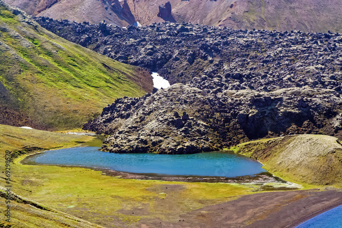 Beautiful icelandic nature landscape, blue volcano crater lake, green hills, lava ashes - Kerid, Iceland