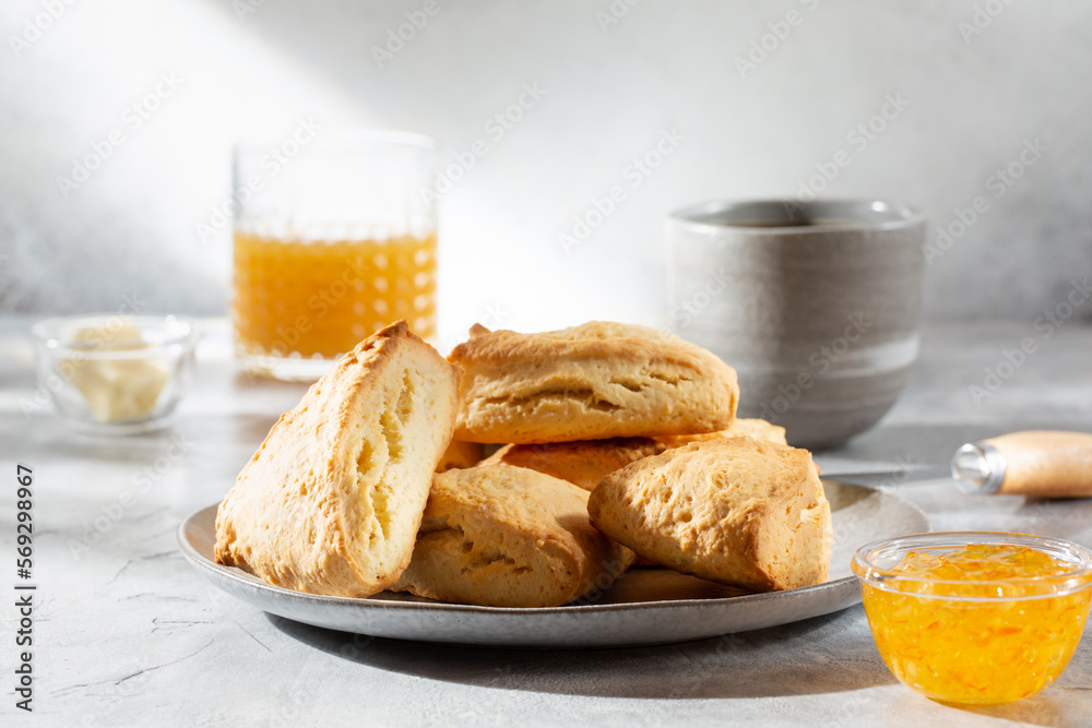 Traditional British scones served with orange jam on gray background. Traditional British scones served with orange jam on gray background.