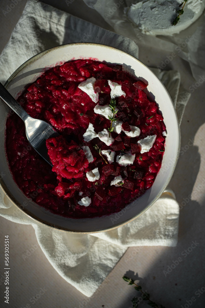 Homemade beetroot risotto with goat cheese and thyme 