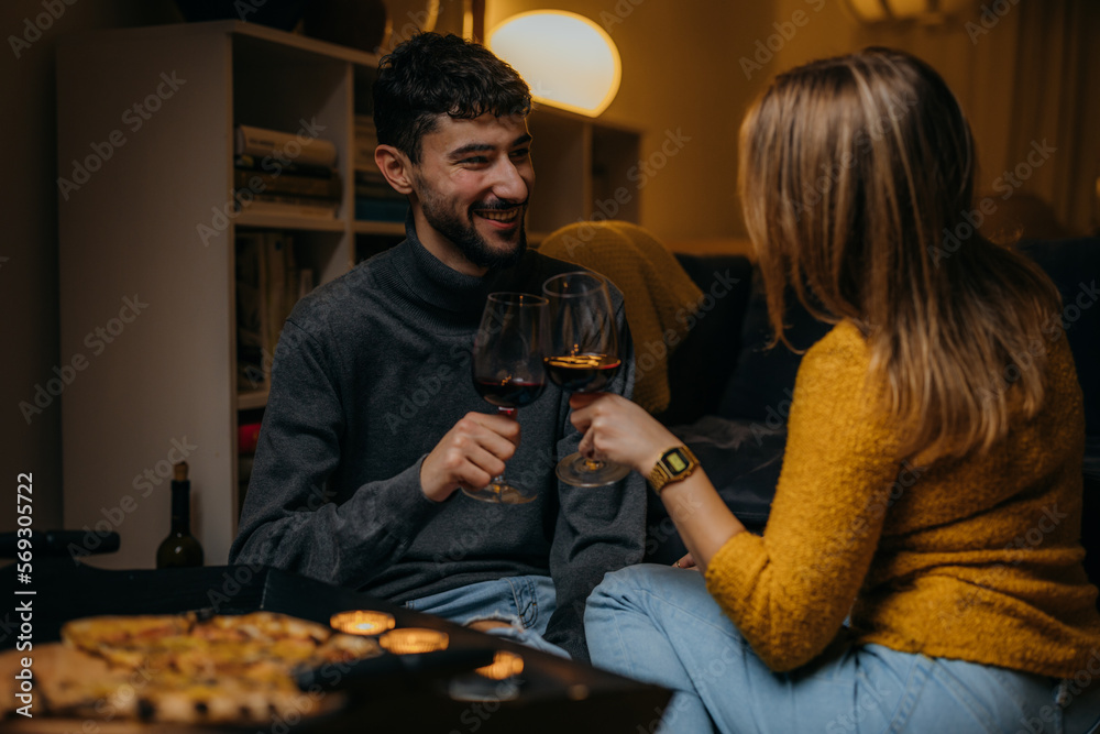 Boyfriend and girlfriend have a toast with a glass of red wine