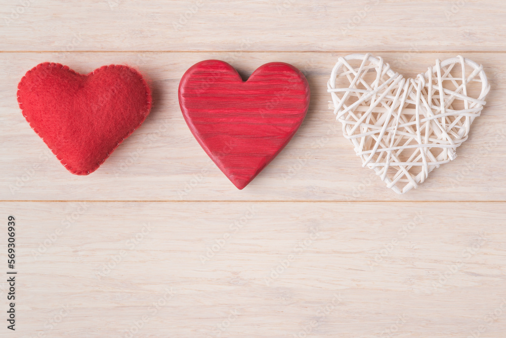 Three different decorative Valentines hearts on light wooden background with copy space. Valentine’s Day greeting card template Three different decorative Valentines hearts on light wooden background with copy space. Valentine’s Day greeting card template