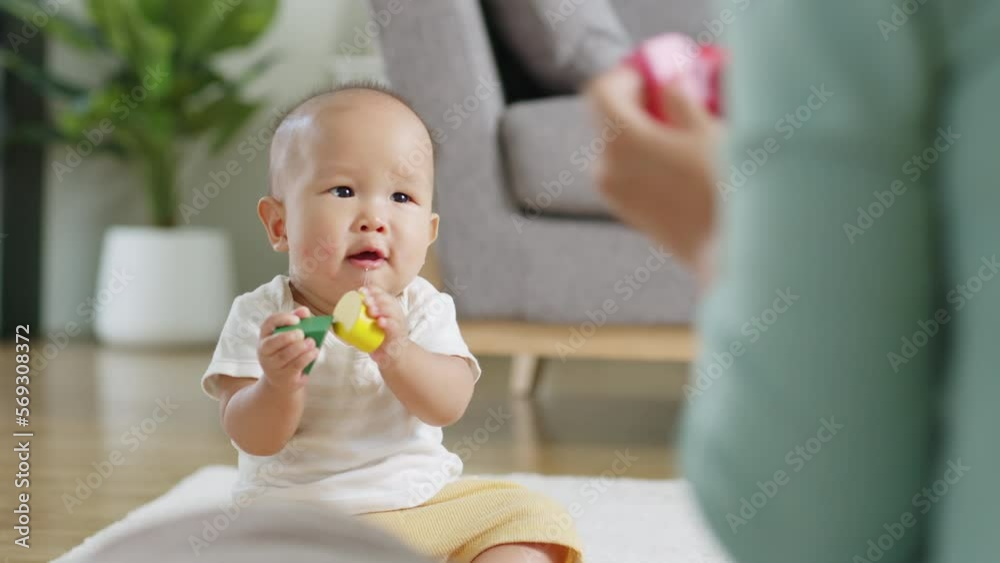Asian Mother playing toys with baby toddler at home Asian Mother playing toys with baby toddler at home