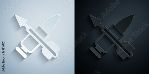Paper cut Crossed bullet with arrow icon isolated on grey and black background. Paper art style. Vector