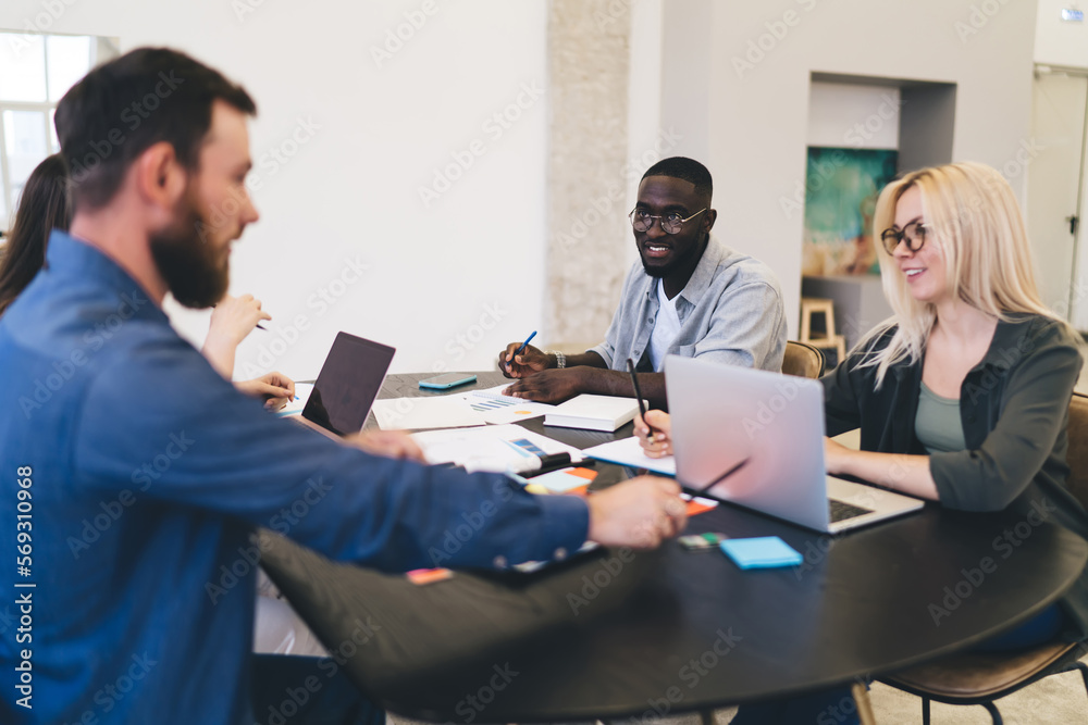 Group of diverse colleagues working on project in office Group of diverse colleagues working on project in office