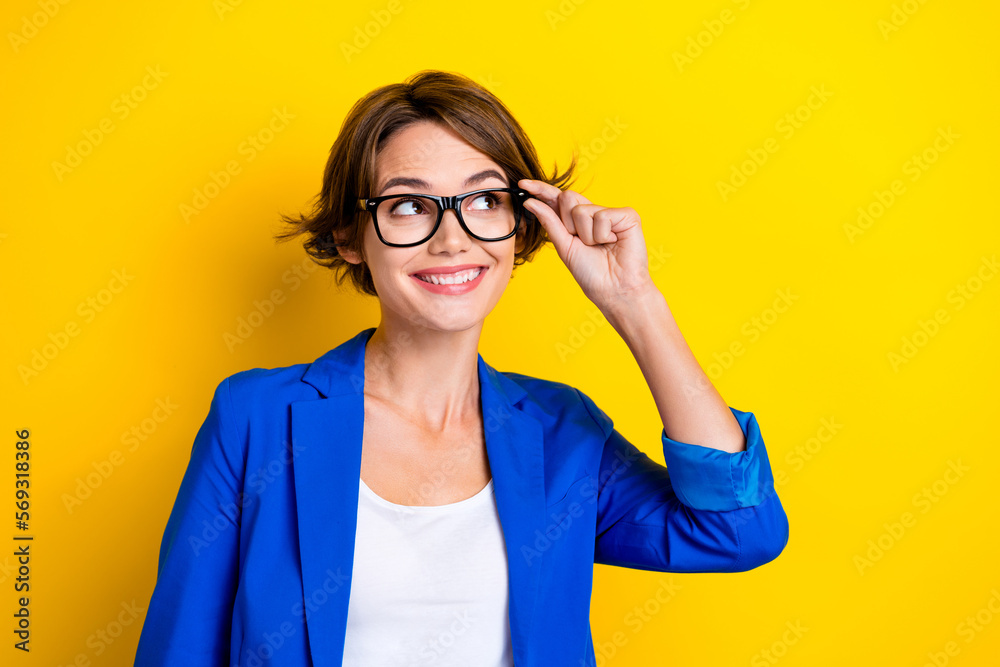 Photo of dreaming cute minded businesswoman touch eyewear specs smiling wear trendy vision glasses look mockup isolated on yellow color background