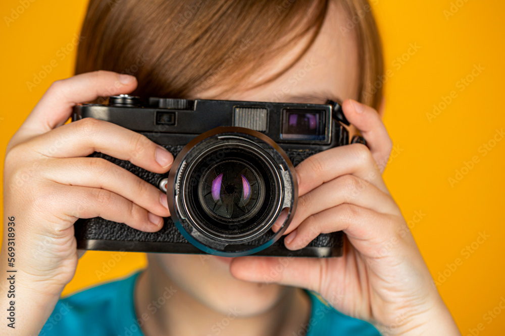 Child in studio with professional camera. Boy using a cameras. Baby boy with camera. Cheerful smiling child holding a cameras. Little boy on a taking a photo using a vintage camera Child in studio with professional camera. Boy using a cameras. Baby boy with camera. Cheerful smiling child holding a cameras. Little boy on a taking a photo using a vintage camera