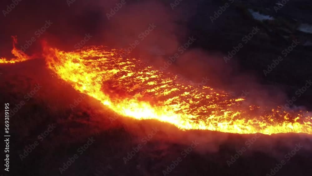 spring grass fire at night aerial video. drone footage over dry grass burning. long periods of hot and dry weather increase the risk of grass fires. climate change, global warming, heatwaves spring grass fire at night aerial video. drone footage over dry grass burning. long periods of hot and dry weather increase the risk of grass fires. climate change, global warming, heatwaves