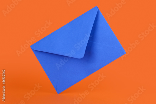 Blue paper envelope on orange background