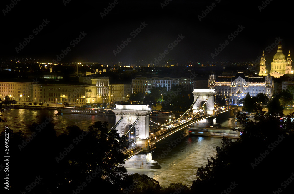 The Széchenyi Chain Bridge is a chain bridge that spans the River Danube between Buda and Pest, the western and eastern sides of Budapest.
