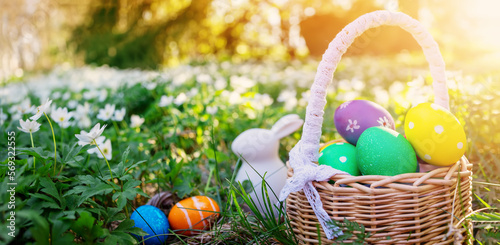 Canvas Print Background of the spring field with rabbit toy and basket with colourful eggs on it