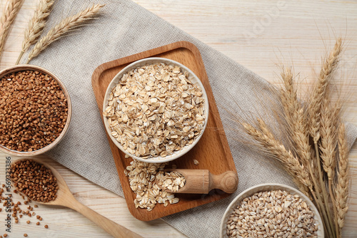 Composition with different cereals and spikelets on wooden background photo