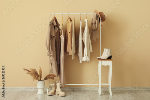Rack with stylish clothes in interior of dressing room